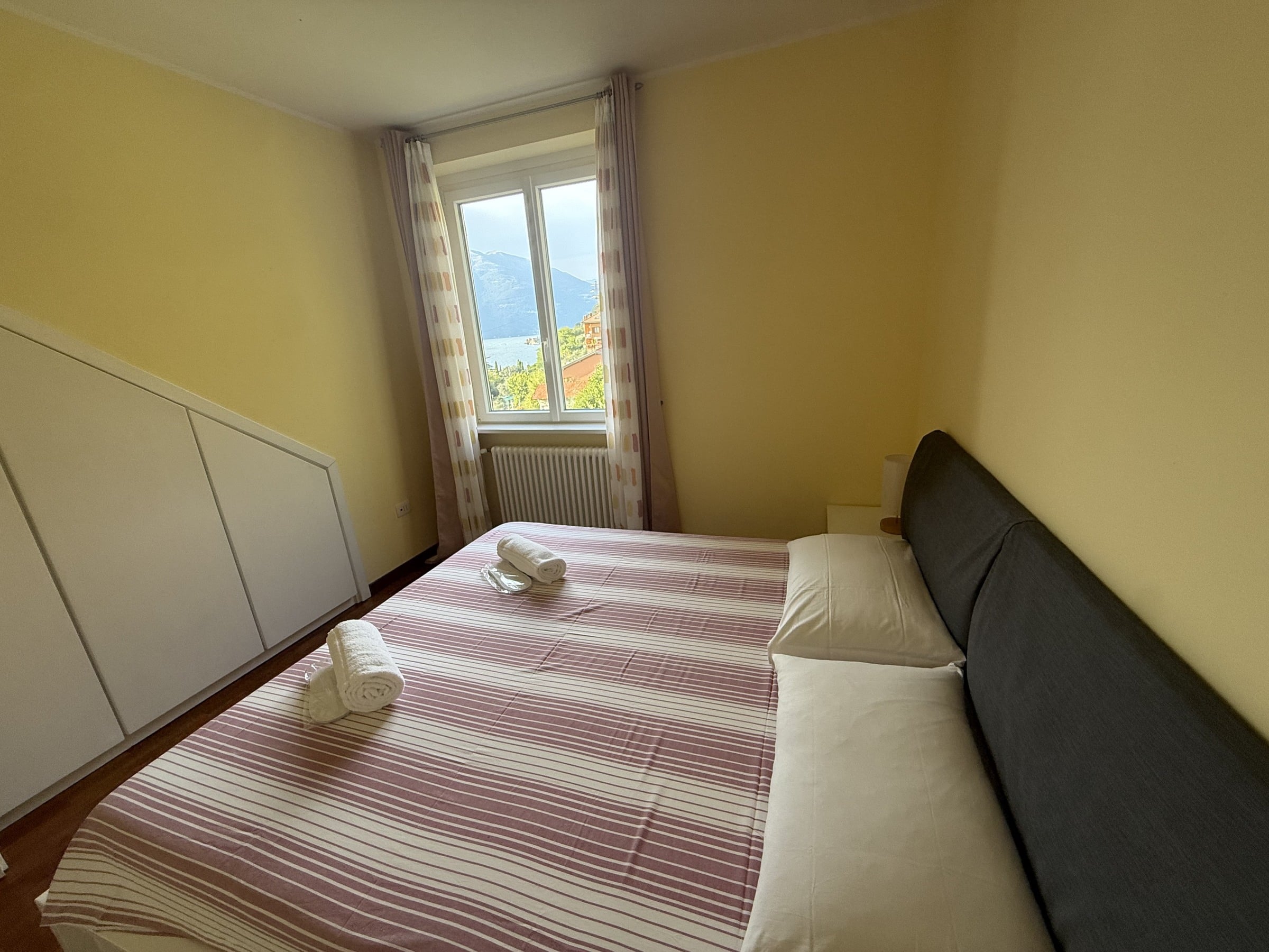 Second double bedroom prepared with white linen and towels